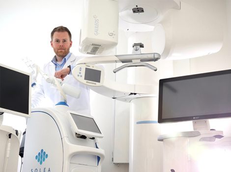 Dr. Tubo with advanced technology, including CBCT and dental laser