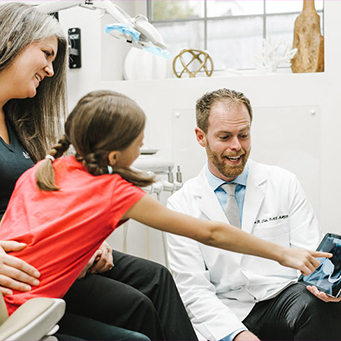 Dentist working with young dental patient