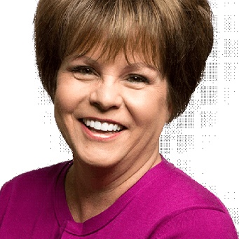 Woman with brown hair smiling in purple shirt