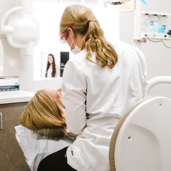 woman laid back in dental chair during appointment