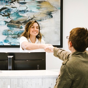 shaking hands with front desk staff