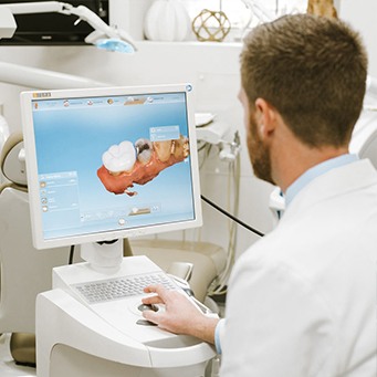 Dr. Tubo looking at digital image of part of the smile