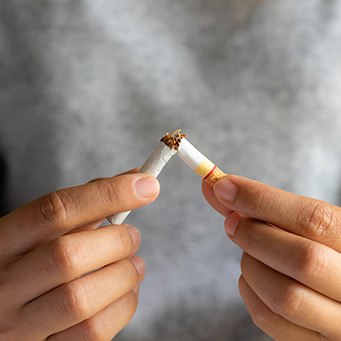 Closeup of patient breaking cigarette