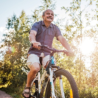 Man smiling while riding his bike
