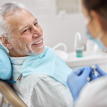 a man speaking with a dentist about dental implants