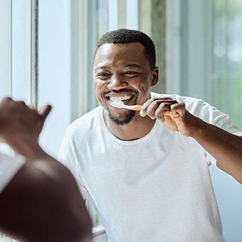 a man brushing his teeth