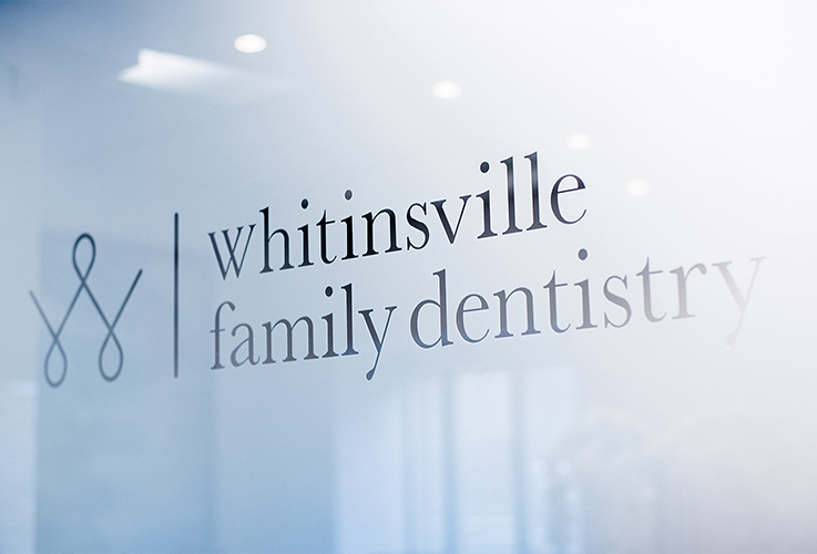Whitinsville Family Dentistry logo on front door of dental office