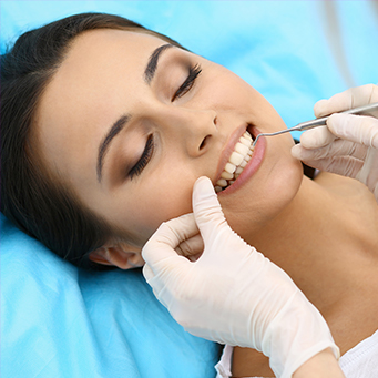 Woman receiving scaling and root planing treatment