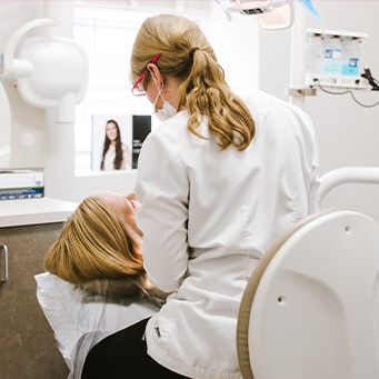 Dentist performing oral cancer screening