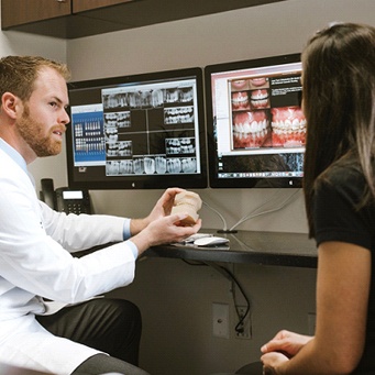 Dr. Tubo showing patient smile on computer