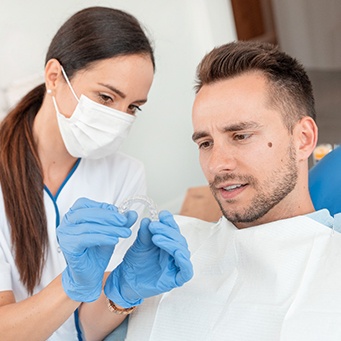 Teenager holding SureSmile® aligner