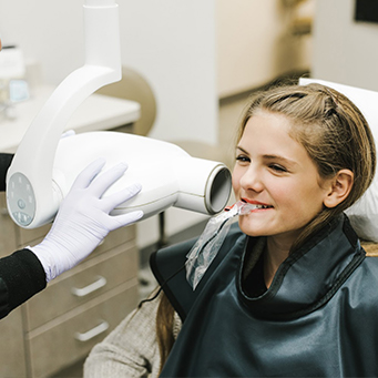 Woman in dental chair receiving digital x-rays