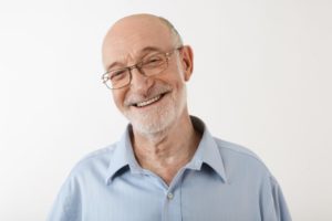 Older man smiling with a full set of teeth