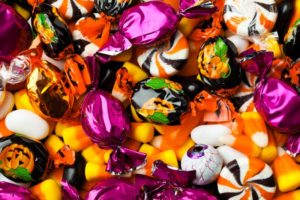 Various Halloween candy spread out on a table