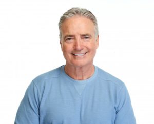 Older man smiling with dentures