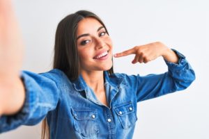 Woman with beautiful smile showing off her teeth