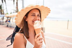 Woman smiling outside with ice cream
