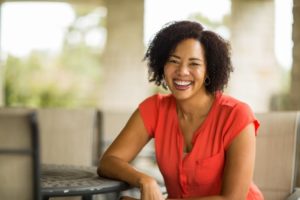 Middle-aged woman with beautiful face smiling while sitting