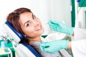 Woman smiling while sitting in dental chair