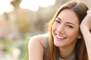 oung woman smiling while standing outside