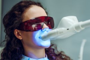 Woman undergoing in-office teeth whitening