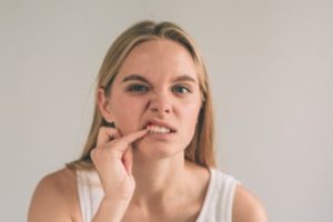 Woman inspecting her smile.  