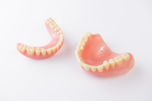 set of broken dentures on a table